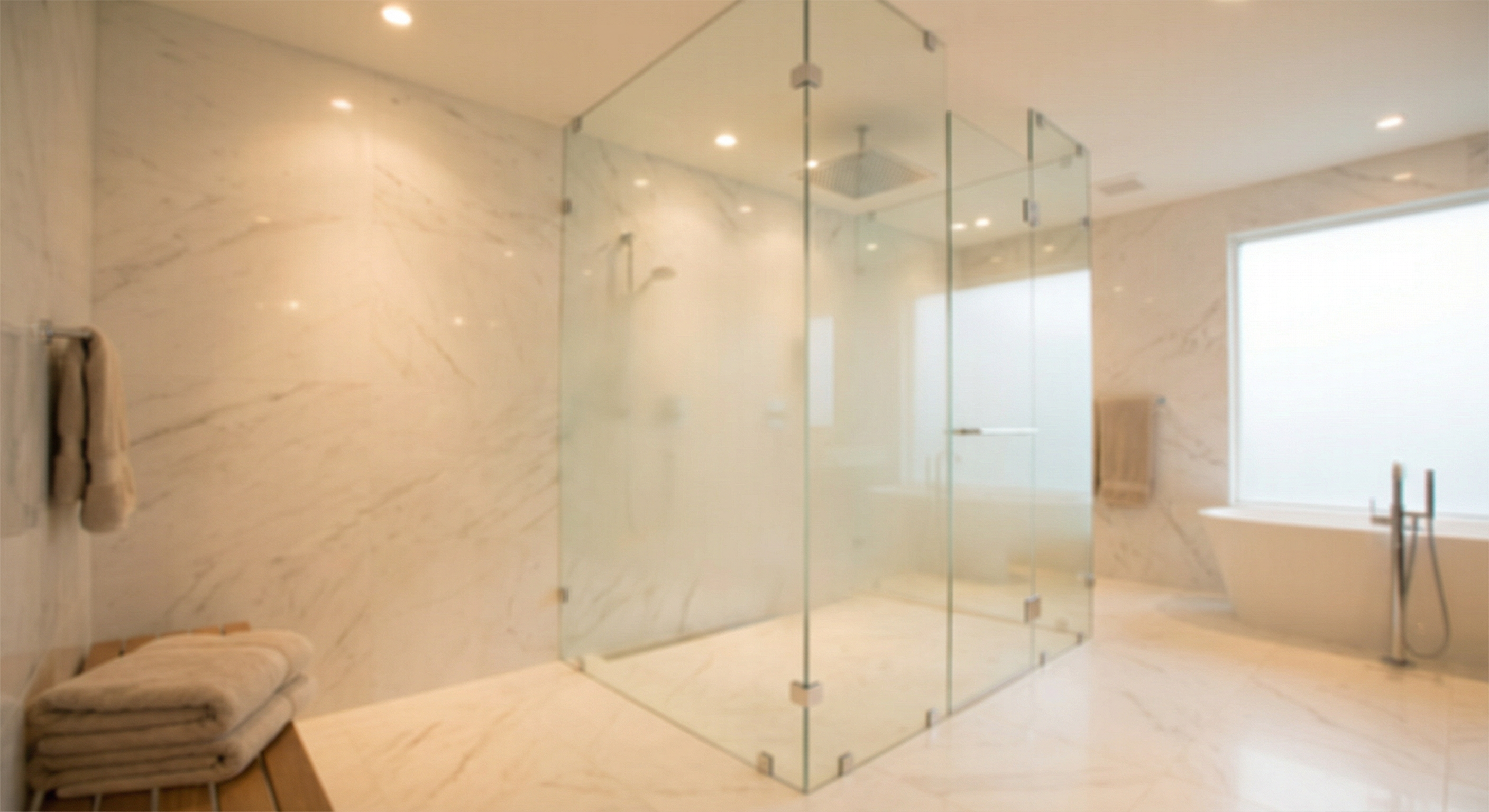 Modern frameless glass shower enclosure in luxury bathroom
